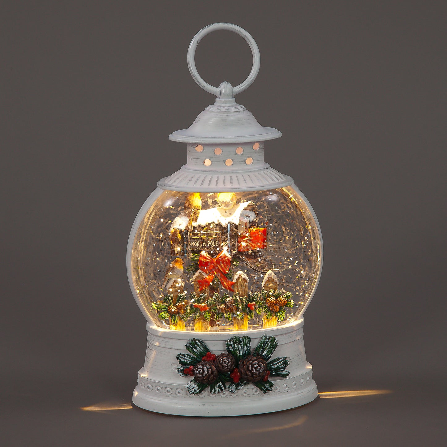 Decorative snow globe lantern with Christmas scene on a dark background