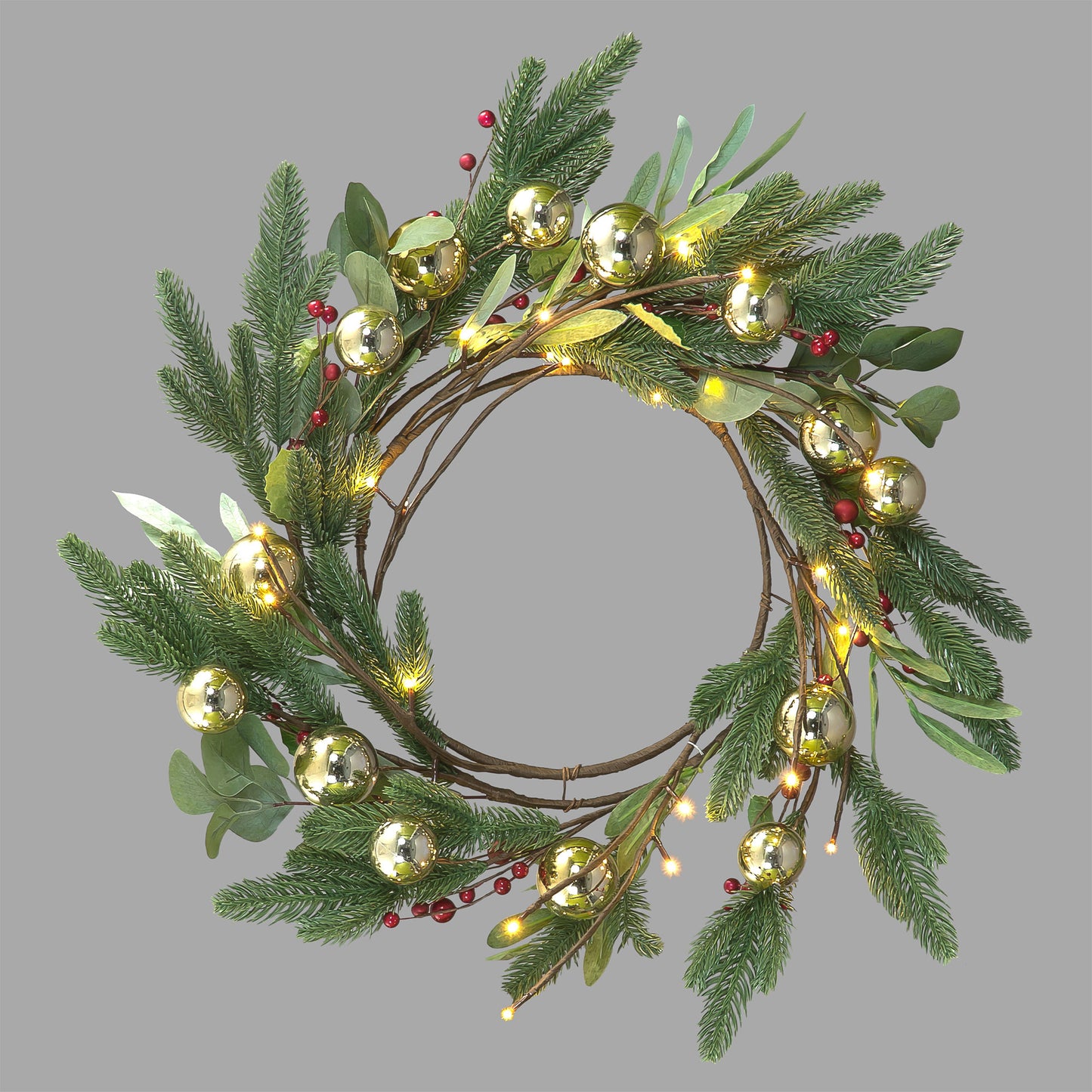 A 60cm round Christmas wreath decorated with a mix of green artificial and natural leaves, red berries, and warm white LED lights.