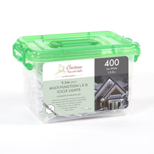 A green plastic container with a label that reads 'Christmas Lights' and '400 LED Ice White', showing a photo of a house with icicle lights and text describing the product features.