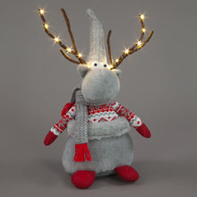Gray reindeer plush toy with lights, sweater, and scarf on a gray background