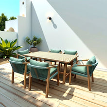 Outdoor patio set with wooden table and chairs on a wooden deck.