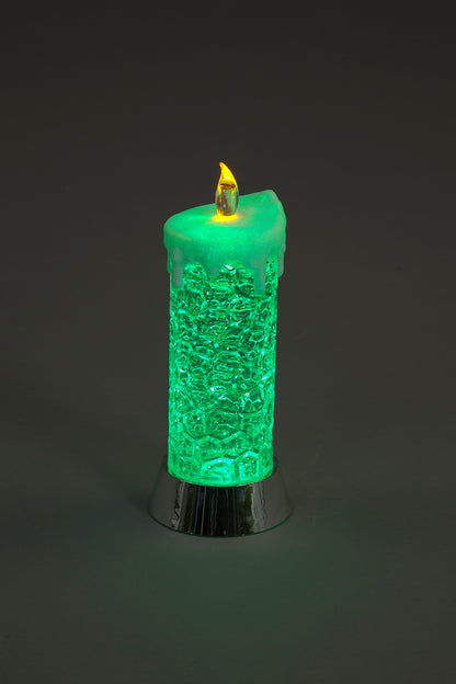 Green textured candle with a flame on a dark background