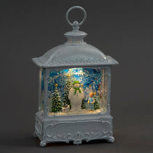 Decorative lantern with a snowman and child scene inside on a dark background